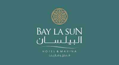 The image shows a logo with the name "Bay la Sun hotel " written in whiteletters.The background is green