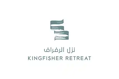 The image shows a logo with the name Kingfisher Retreat" written in green  letters.The background is white