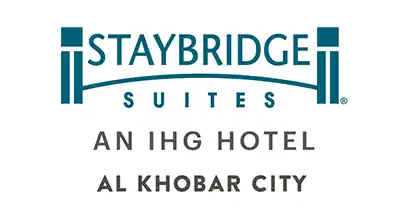 The image shows a logo with the name "Staybridge Suites Al Khoba " written in blue letters.The background is white