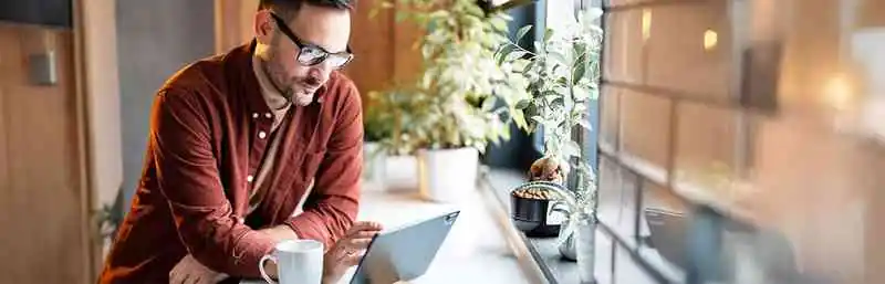 the image shows a man working on a computer